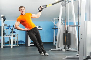 bodybuilder man doing exercises in fitness club