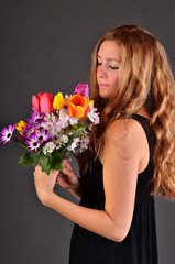 Springtime: young woman with a colorful bouquet of flowers