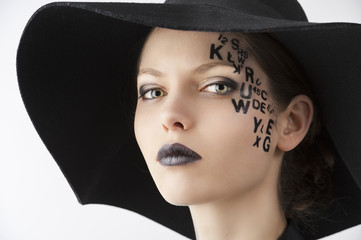 the letter on the face creative makeup girl, close-up portrait