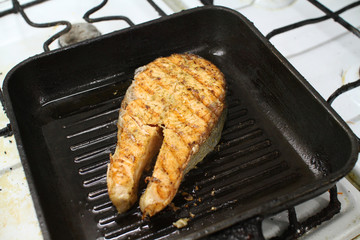 fresh slice of salmon in the frying pan