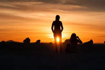 Foto op Plexiglas Two girls watch the sunset in the  White Desert, Egypt. © cornfield