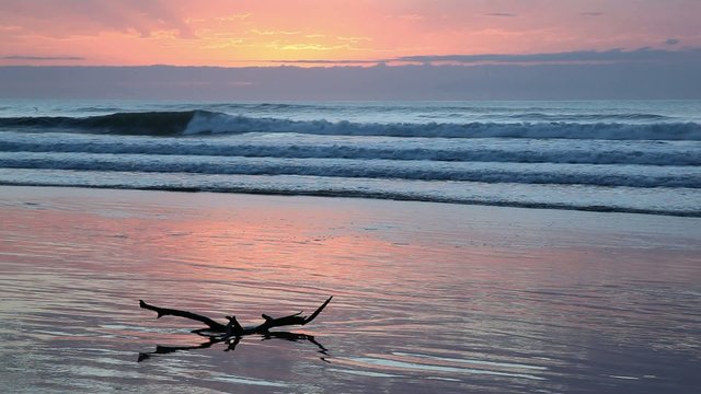 Seascape at sunrise with soft pastel colors