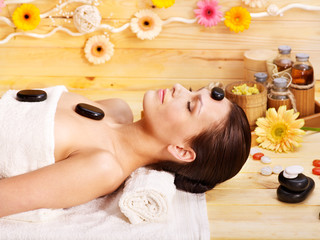 Obraz na płótnie Canvas Woman getting stone therapy massage .