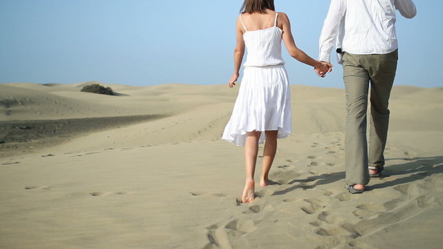 Loving couple walking in the desert