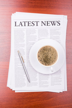 The newspaper LATEST NEWS on table  and coffee