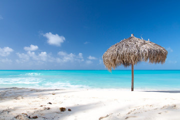 Fototapeta na wymiar Beach Umbrella on a perfect white beach in front of Sea
