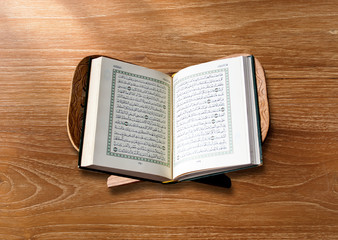 The Holy Quran  on wood background