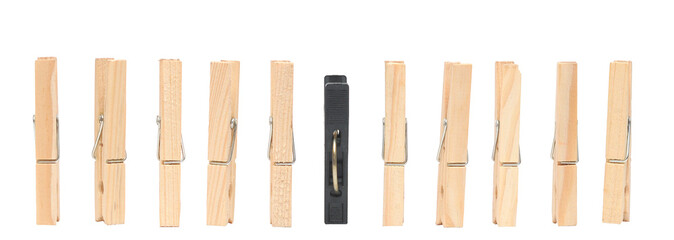 old wooden pins and one black plastic pin isolated on white