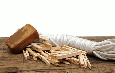 Soap, clothespins and rope on rustic table