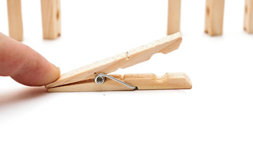 clothes pin in hand, isolated on white background