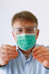 Dentist with tools, isolated on white background