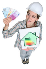 portrait of cute female heating engineer holding bank notes