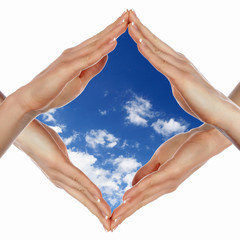 Hands and blue cloudy sky