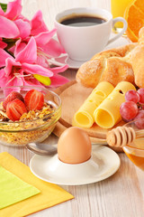 Breakfast with coffee, rolls, egg, orange juice and muesli