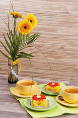tea with cake and gerberas flowers