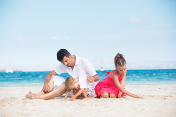Fototapeta na wymiar Happy family on tropical beach