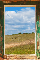 Fototapeta premium View the landscape from the old window.