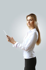 Young beautiful woman in business wear at work