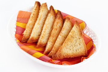 Some roasted toasts in a white plate