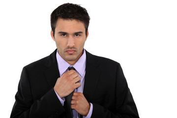 Businessman fixing his tie