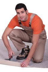 Man placing carpet