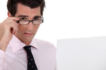 Businessman holding his glasses