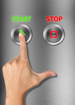 Human hand pressing start button on metalic background