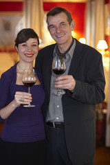 Happy smiling middle aged couple celebrating.