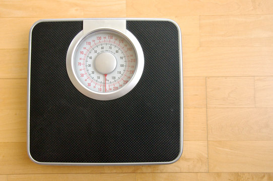analog black body weigh scale on wood background
