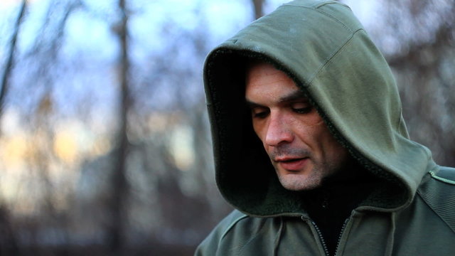 Hooded criminal smoking, close up