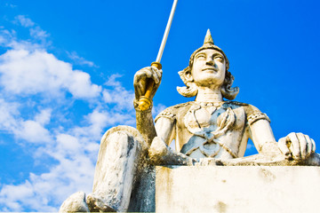 Fototapeta na wymiar white angel in front of Thai church with blue sky