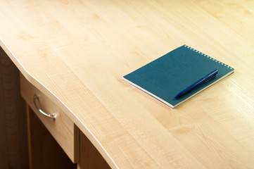 Blue notebook with pen