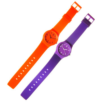 orange and violet plastic watches isolated on white