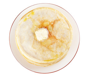 A stack of thin pancakes with butter