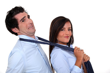 Woman grabbing man by tie