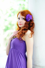 Fototapeta premium Young woman portrait with flower in her hair.