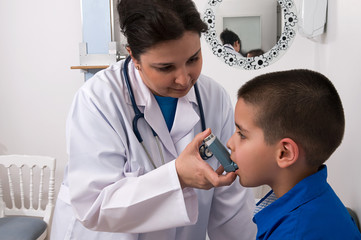 Little boy with asthma using nebuliser at clinic