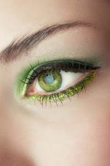 eye of woman with green make-up