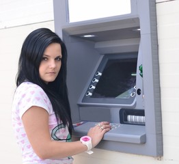 Fototapeta na wymiar woman using ATM