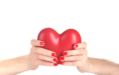 Fototapeta premium Red heart in woman's hands isolated on white