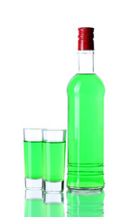 bottle and two glasses of absinthe isolated on white