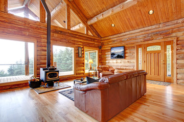 Luxury log cabin living room with leather sofa.