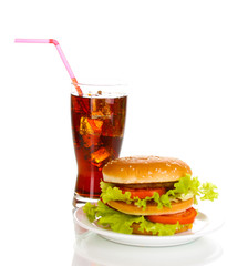 Big and tasty hamburger on plate with cola isolated on white