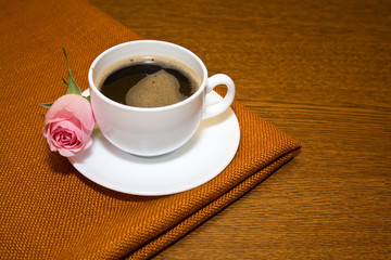 cup of coffee and of delicate pink roses