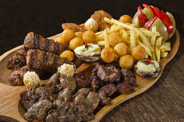 Rustic tray with various meats and cheese balls - isolated
