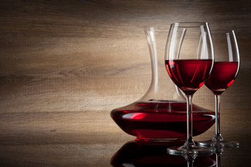 two Wine glass and decanter on a wooden Background