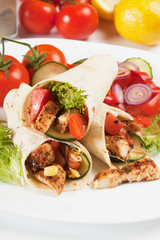 Grilled chicken and salad in tortilla wrap