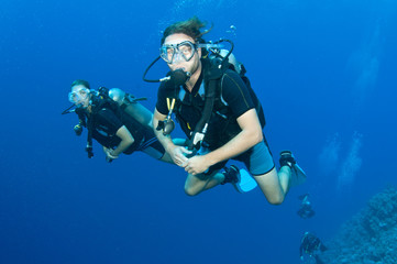 man and woman scuba dive togeather