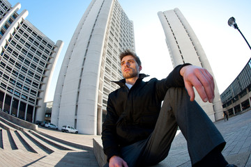 Young elegant man portrait with building background.