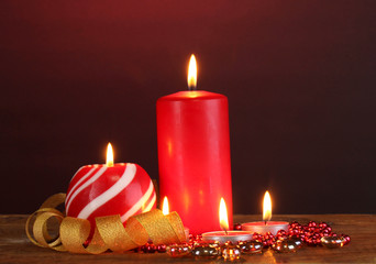 Wonderful candles on wooden table on dark background
